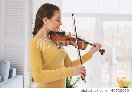 Attentive female person practicing new work Attentive female person practicing new work 40732010