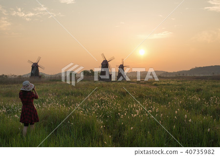 Sunrise in the fields with windmills 40735982
