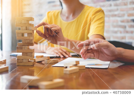 Group of business creative people building tower by wooden block Group of business creative people building tower by wooden block 40738009