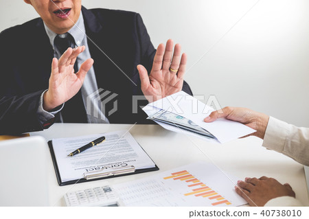 Businessman refusing or rejecting money in the envelope - anti b Businessman refusing or rejecting money in the envelope - anti b 40738010