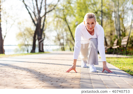 Pleasant aged woman starting to run 40740753
