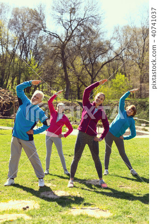 Inspired people doing exercises in the park Inspired people doing exercises in the park 40741037