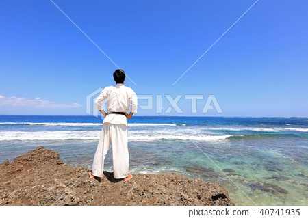 A man relaxing on a beautiful beach in the southern country A man relaxing on a beautiful beach in the southern country 40741935
