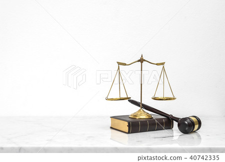 Wooden gavel and law book put on white marble 40742335