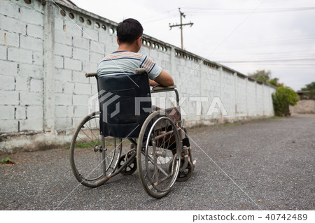 Young man sitting on wheelchair, Disabled concept outdoor. Young man sitting on wheelchair, Disabled concept outdoor. 40742489