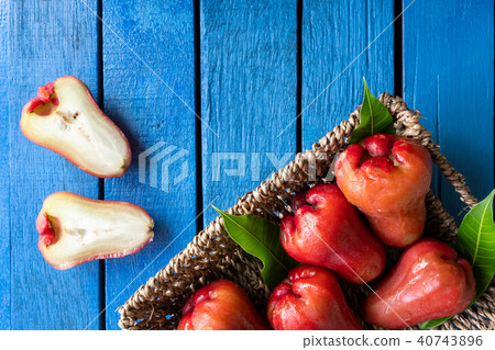 ose apples in basket on blue wooden table 40743896