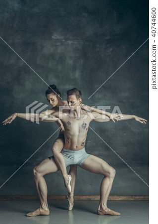 The young modern ballet dancers posing on gray studio background The young modern ballet dancers posing on gray studio background 40744600