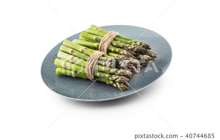 Fresh Asparagus on plate isolated on white. Fresh Asparagus on plate isolated on white. 40744685