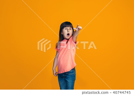 Beautiful teen girl looking suprised isolated on orange 40744745