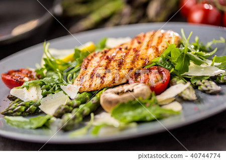Grilled chicken breast with asparagus. 40744774