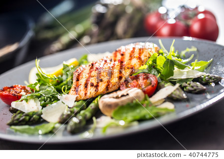 Grilled chicken breast with asparagus. 40744775