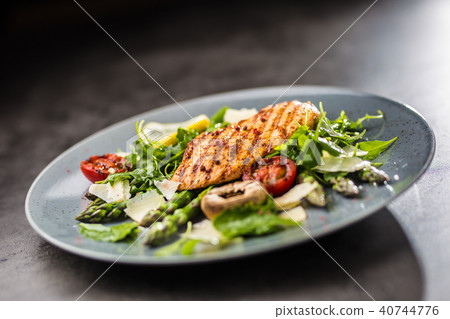 Grilled chicken breast with asparagus. 40744776