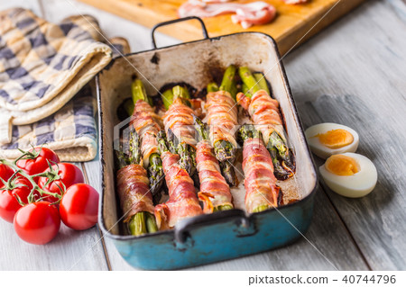 Tasty food bacon wrapped asparagus in frying pan 40744796