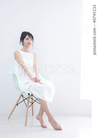 A young woman sitting on a chair 40745132
