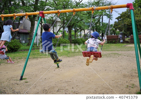 A child playing with a swing in a park 40745379