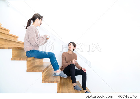 A couple sitting on the stairs 40746170