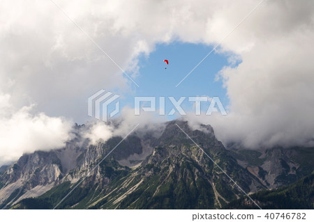 Paraglider flying over Dachstein Alps, Austria 40746782