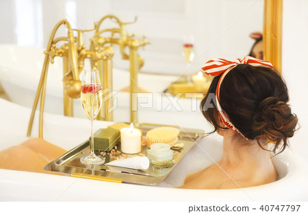 Girl relaxing in bath on light background 40747797