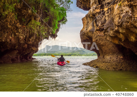 Kayaking under high cliffs in Thailand 40748860