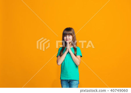Happy success teen girl celebrating being a winner. Dynamic energetic image of female model 40749060