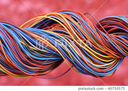 Multicolored electrical cable on red background Multicolored electrical cable on red background 40750575