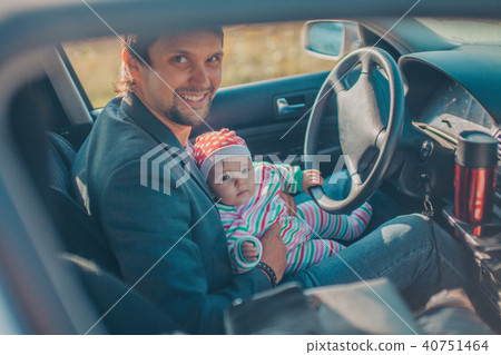 A little girl with her father pretends to drive a car. Concept photo of children education, learning A little girl with her father pretends to drive a car. Concept photo of children education, learning 40751464