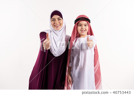 Arab boy and woman in hijab show thumbs up. 40753443