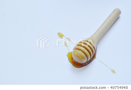 wooden honey scoop on white background 40754948