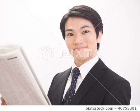 Businessman looking at newspaper stock column Businessman looking at newspaper stock column 40755391