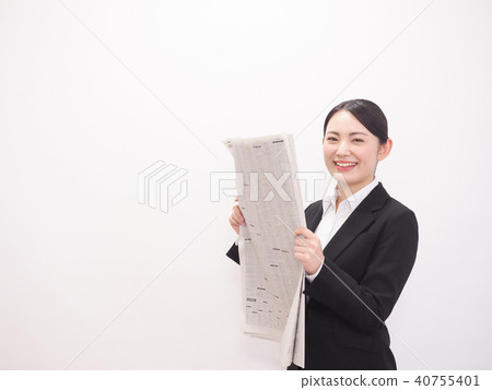 Laughing business woman looking at newspaper stock column 40755401