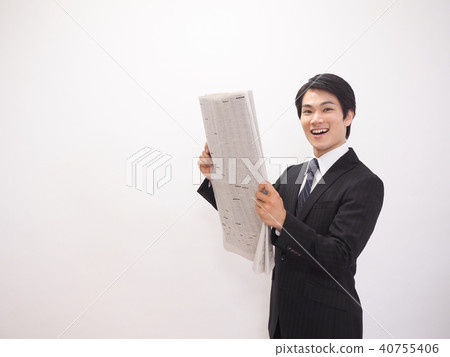 Laughing businessman looking at newspaper stock column Laughing businessman looking at newspaper stock column 40755406
