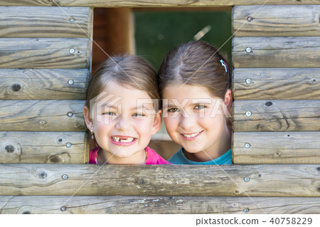 Two sisters playing in tree house 40758229