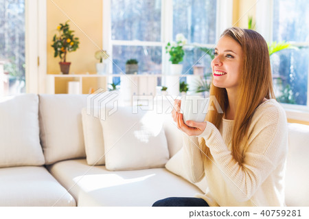 Happy young woman drinking coffee 40759281