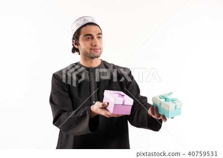 Arab man holds in hands two gift boxes. 40759531