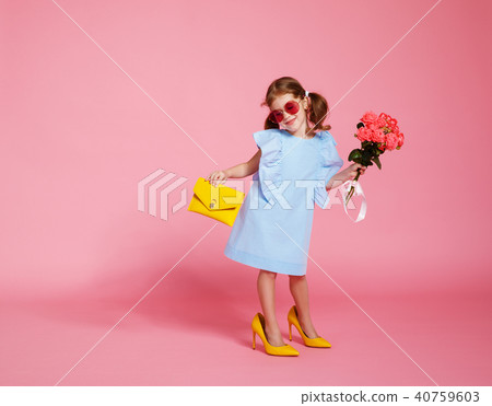 funny child girl in big mother's shoes funny child girl in big mother's shoes 40759603