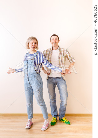 Image of man and woman in new empty apartment Image of man and woman in new empty apartment 40760625