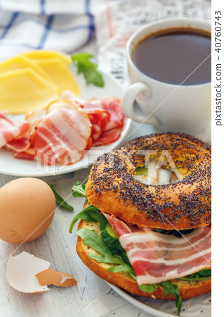 Bagel with arugula,cucumber and bacon. Bagel with arugula,cucumber and bacon. 40760743