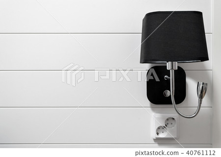 Lamp-bracket on a white wall. Lamp-bracket on a white wall. 40761112