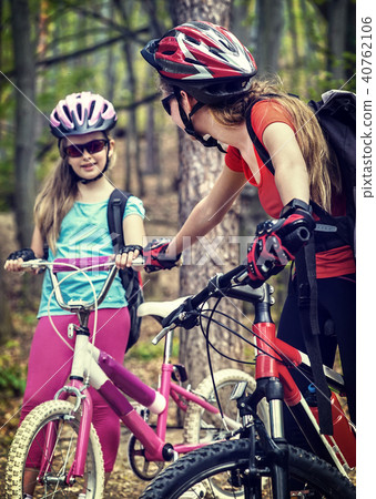 Bicyclist child ride on bicycle path in city. Children go down stairs in park. Bicyclist child ride on bicycle path in city. Children go down stairs in park. 40762106