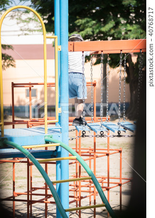 A boy playing in a park A boy playing in a park 40768717