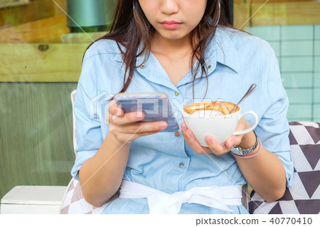 Business women using cellphone in vintage cafe Business women using cellphone in vintage cafe 40770410