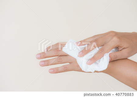 Woman cleaning her hands with a tissue Woman cleaning her hands with a tissue 40770883