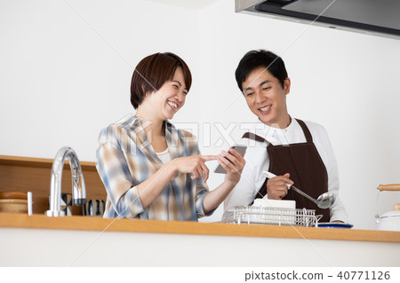 Husband cooking while watching recipe video 40771126