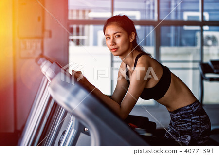 woman running in machine treadmill at fitness gym 40771391