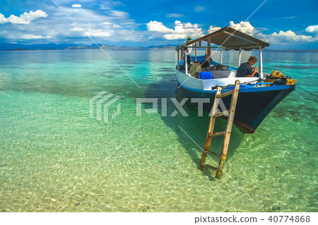 Woman in a wooden boat on a snorkeling trip Woman in a wooden boat on a snorkeling trip 40774868