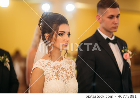 Bride and groom on wedding ceremony in church 40775881