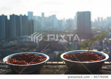 Bowls of ground red pepper drying 40776096