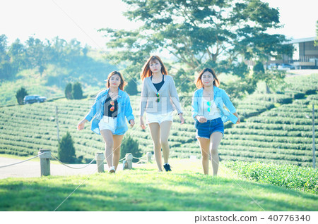 Three Asia girls lying on grass in sunglasses 40776340