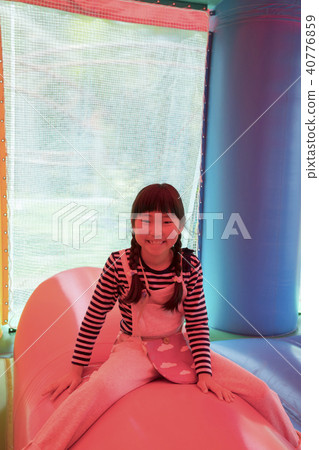 A child playing with amusement park air playground equipment 40776859