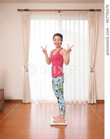 A lady who is weighing and rejoicing A lady who is weighing and rejoicing 40776876